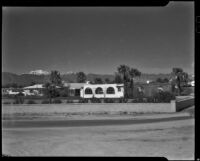 Houses beyond  a low brick wall, Palm Springs, 1935