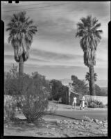 Two women standing in front of the entrance gate to the home of King C. Gillette, Palm Springs, 1935