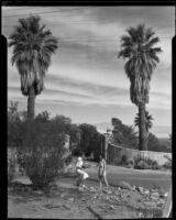 Two women across from the entrance gate to the home of King C. Gillette, Palm Springs, 1935
