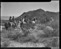 Vacationers on horseback in the desert en route to breakfast with The Desert Riders, Palm Springs vicinity, 1936