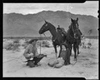 Cowboy serenading a woman vacationer in the desert during a Desert Riders breakfast expedition, Palm Springs vicinity, 1936