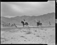 Vacationers on horseback in the desert arriving at a breakfast prepared by The Desert Riders, Palm Springs vicinity, 1936