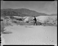 Model Mona Ohrtland walking on a sand dune, Palm Springs vicinity, 1940-1941