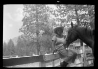 Carolyn Bartlett with a horse on vacation, 1937