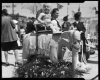 Toddler riding an elephant at the Annual Ocean Park Children's Floral Parade, Santa Monica, 1936