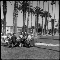 People gathered at a folding table at Palisades Park, Santa Monica