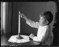 Boy lighting a candle at the Children's Home Society, Los Angeles, 1935-1960