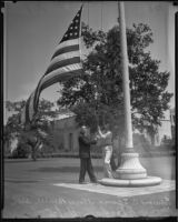 Edward E. Spence and Norman A. Pabst fly the flag at half mast at City Hall upon news of the death of Will Rogers, Beverly Hills, 1935