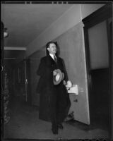 Robert S. James, suspect in Mary Emma James murder case, walking in hallway, Los Angles, 1935 or 1936