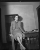 Lois Wright, witness in Mary Emma James murder case, seated on table, Los Angeles, 1935