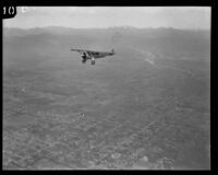 Aerial view of streets, river, mountains, and airplane, Los Angeles, [1930s?]