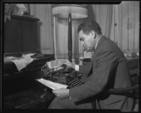 Police detective Howard Nutt examining typewriter used in Mary B. Skeele kidnap case, Pasadena, 1933