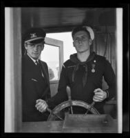Sea Scout Don Crews at helm of Pinta, Balboa peninsula (Newport Beach), 1937