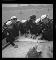 Sea Scouts and officer aboard Pinta with map, Balboa peninsula (Newport Beach), 1937