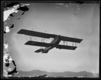 Biplane flying near Griffith Park Airport, Los Angeles, [1928?]