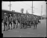 California National Guard members walking alongside train on Exposition Boulevard, Los Angeles, circa 1928-1939