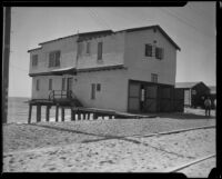 Beach house threatened by tide, Newport Beach, 1933