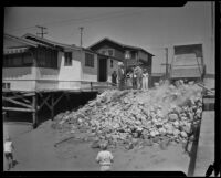Dump truck dropping rocks to protect beach houses threated by tide, Newport Beach, 1934