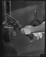 Hands of two orphans on a switch to light the California Pacific International Exposition on opening night, San Diego, 1935