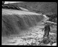 San Fernando Reservoir with man standing near spillway, Granada Hills, 1926