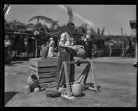 Woman showing terracotta pots at the Old Spanish Days Fiesta, Santa Barbara, 1932