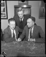 Flood control engineers Paul Baumann, Samuel M. Fisher, and Harold E. Hedger with map of Angeles National Forest, 1934