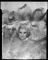 Fan dancer Joyce Baker surrounded by feathers, 1935