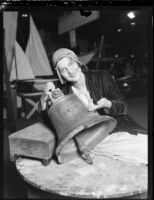 Adelene Yerbysmith ringing antique ship's bell to open Los Angeles Boat Show, Los Angeles, 1930