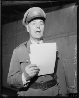 Colonel Reginald Barlow reads from a script, Los Angeles, 1934