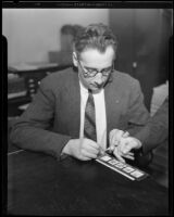 Los Angeles police captain Howard L. Barlow taking fingerprints, Los Angeles, 1934