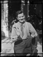 Frank J. Buck, mining engineer, holds a hammer and a rock, Tujunga, 1935