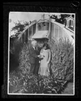 Luther Burbank with Estelle Harriet Robbins in front of greenhouse, Santa Rosa, 1925