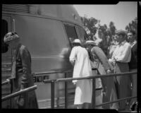 Observers peer into window of Burlington Zephyr train at Exposition Park, Los Angeles, 1934