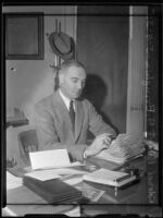 Col. Robert A. Bringham seated at his desk, Los Angeles, 1935