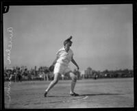Aurelia Brown engaged in a discus throw, circa 1925