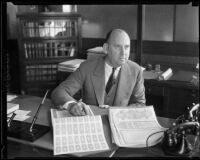 H. L. Byram, Los Angeles County Treasurer and County Tax Collector, sitting at his desk, Los Angeles County, 1934