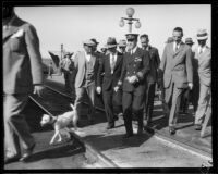 Commander Richard Byrd and his party walk through the railroad yard, Los Angeles, 1928