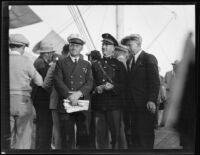 Harold June, Alton Parker and Bernt Balchen stand on the deck of the C. A. Larsen, Los Angeles, 1928
