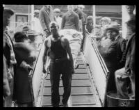 Rescued Wrigley Ocean Marathon swimmer in boat on stretcher, 1927