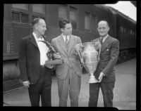 Coach Dean Cromwell, Captain Norman Paul and Athletic Director Bill Hunter with Intercollegiate Championship trophies, Los Angeles, 1935