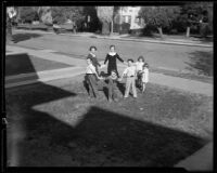 Alice, John, Dorothy, George, Teresa, Vincent, and Mary Cheap play a game in their front yard, Los Angeles, 1933