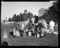 Football coach Howard Jones with player Cal Clemens and 2 others at USC, Los Angeles, circa 1934