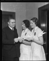 Judge Newcomb Condee, and police women Rose Pickerel and Alla Gilmore hold dance tickets, Los Angeles, 1930s