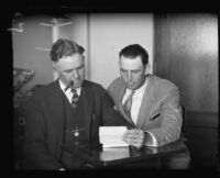 Detective J. B. Worley and man examine paper, 1926