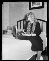 Helen Lee Worthing sits reading a book, California, 1933