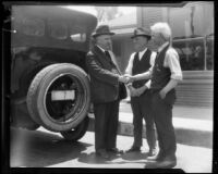 State Treasurer Friend W. Richardson shaking hands with two men, 1922 (?)