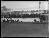 Spectators gather to watch kite-flyers on the beach, Long Beach, between 1920-1939