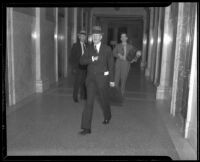Judge Gavin W. Craig walking down a hallway in a courthouse, Los Angeles, 1930s
