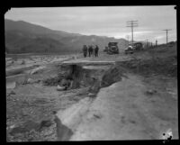 Officials (?) on the edge of the wide path of the flood that followed the failure of the Saint Francis Dam, San Francisquito Canyon (Calif.) (probably), 1928