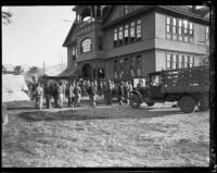 Flood relief workers outside a Victorian building after the flood resulting from the failure of the St. Francis Dam, Santa Clara River Valley, 1928